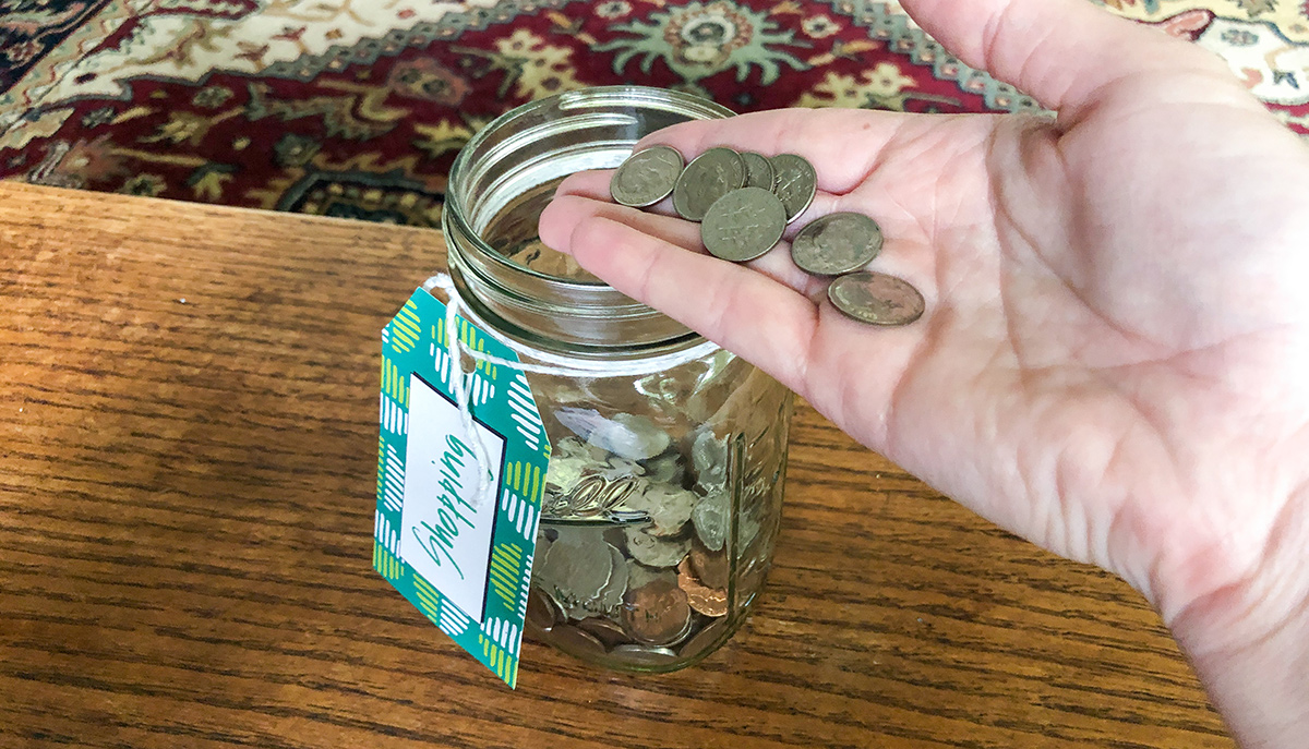 Adding dimes to money jar